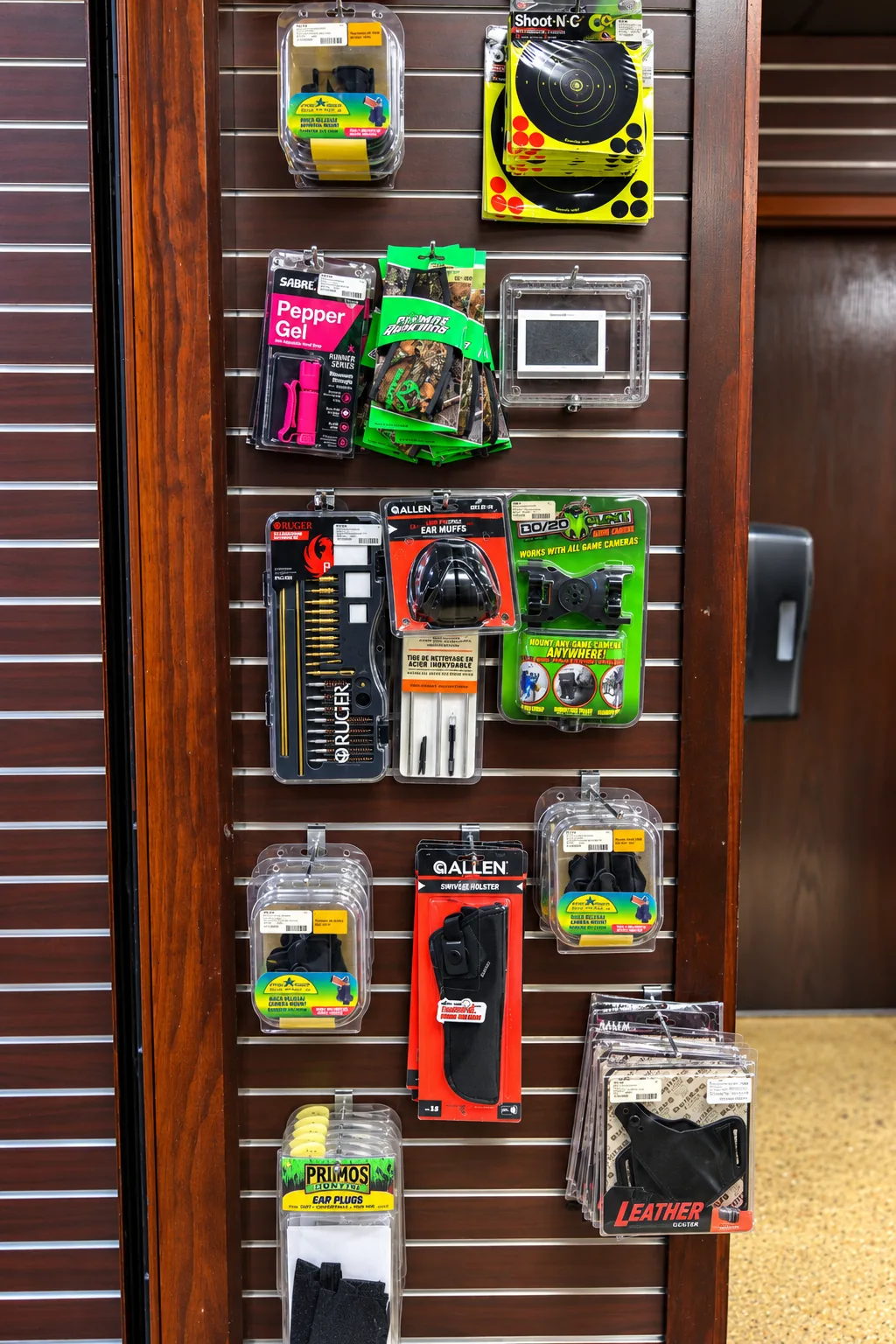 Outdoor gear slatwall display with holsters, ear protection and cleaning kits at Twin Cities Gun & Pawn