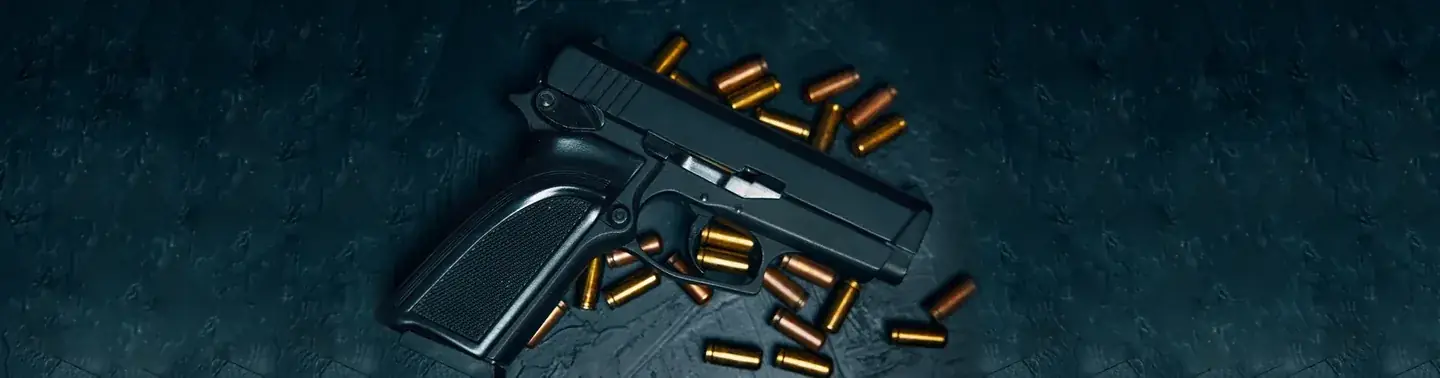 Handgun with scattered ammunition on dark blue surface