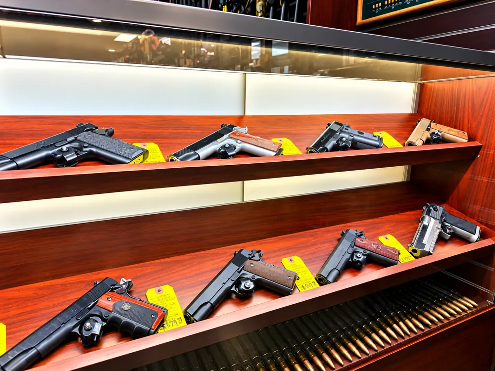 1911 pistols and ammunition in a display case at Twin Cities Gun & Pawn