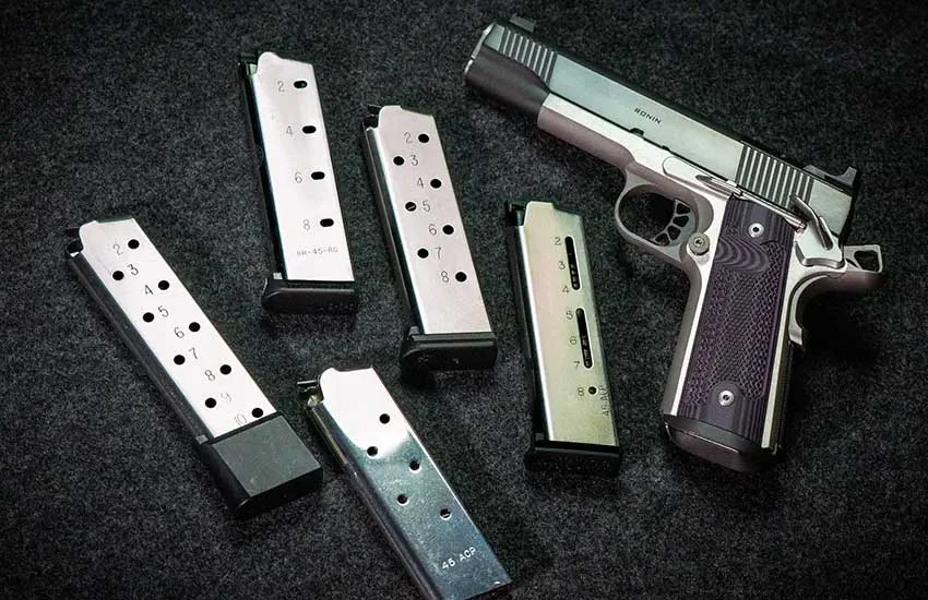 Pistol magazines and 1911 handgun at Twin Cities Gun & Pawn